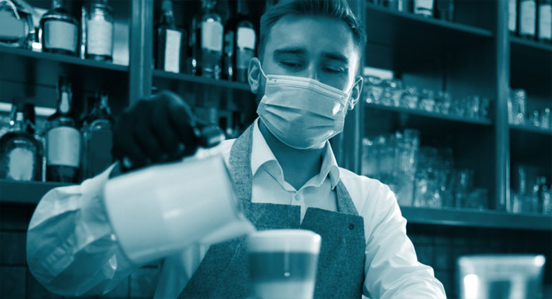 Man working in hospitality pouring drink