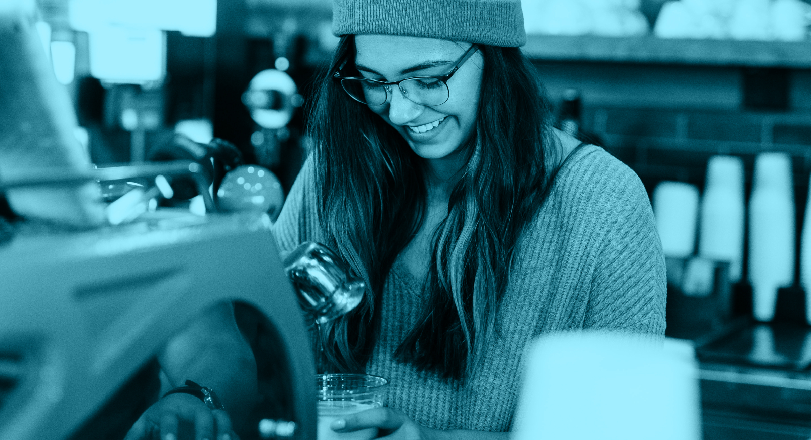 Young female barista smiling at work