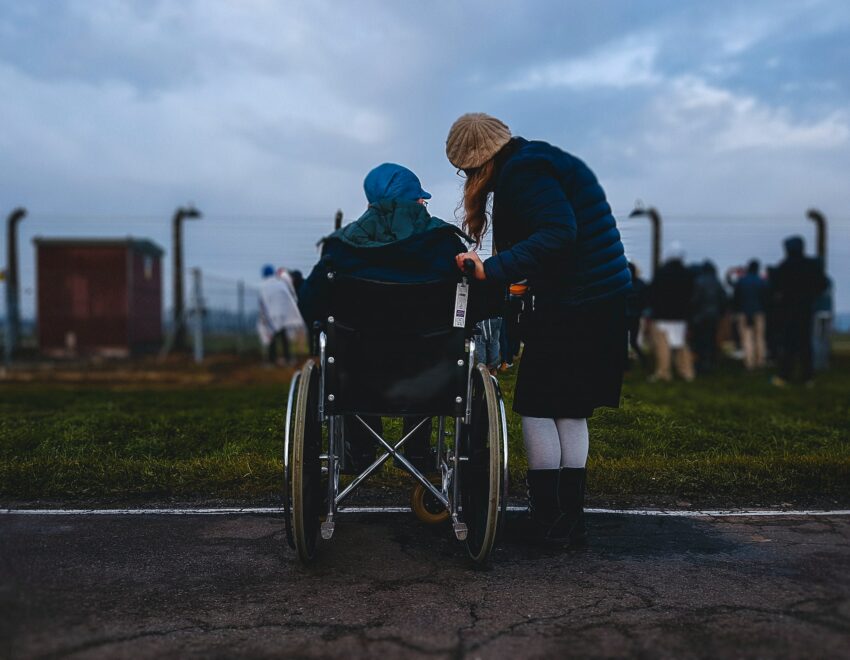 Woman talking with man in a wheelchair