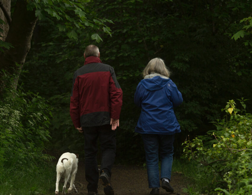 Retired couple walking the dog