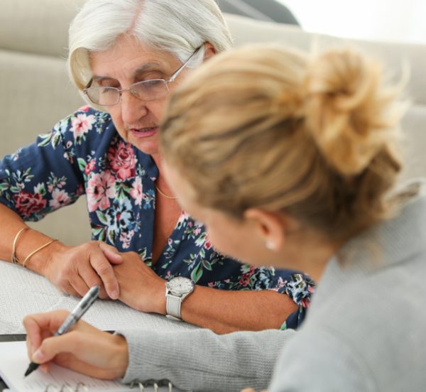 Senior woman consulting with an office worker